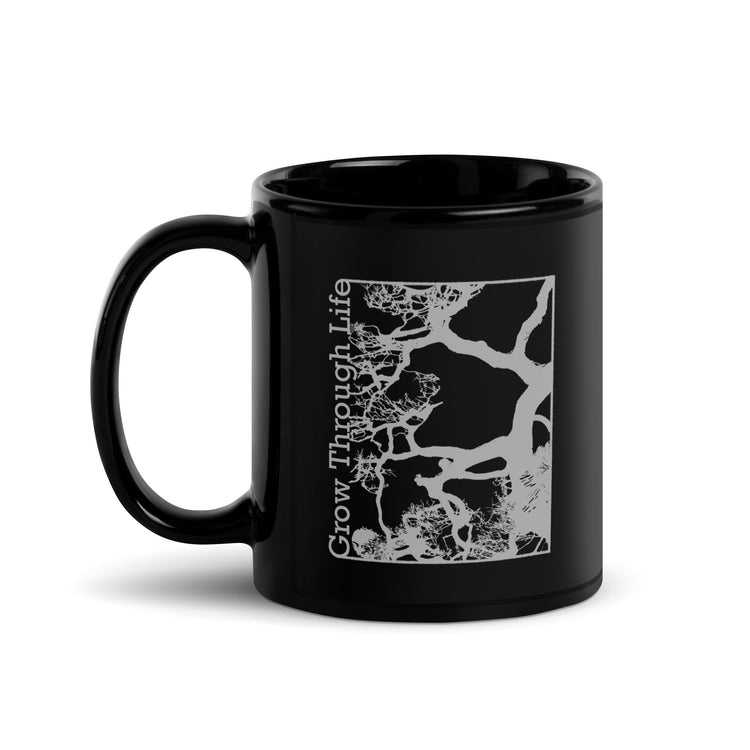 Black mug with light gray symbolic tree design, inspirational nature-themed drinkware. View 1