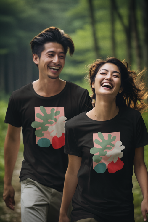 Happy couple wearing matching abstract botanical t-shirts in black, featuring a modern nature-inspired design. Perfect for art lovers, casual style, and outdoor adventures.