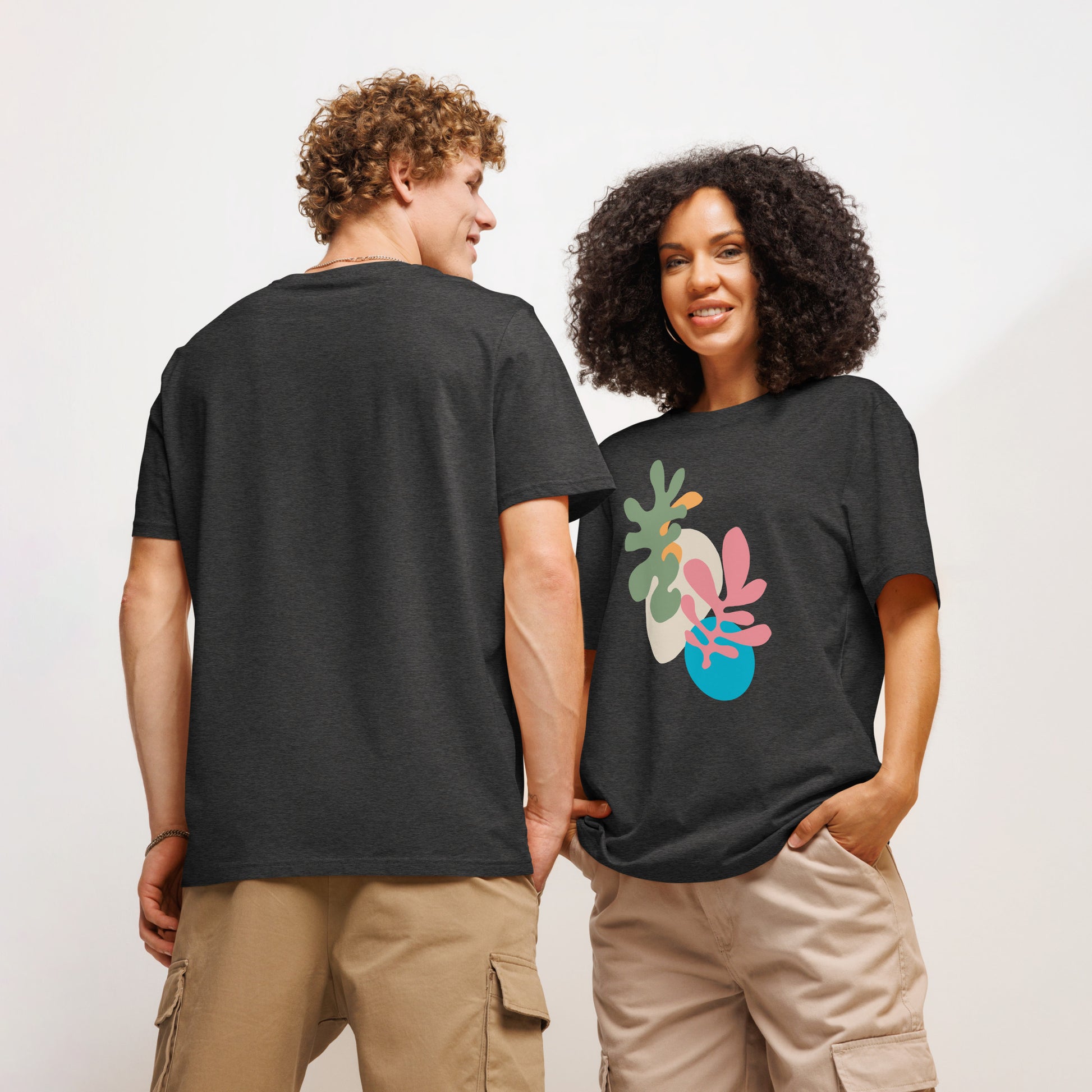 Two models wearing organic t-shirts with colorful leaf designs