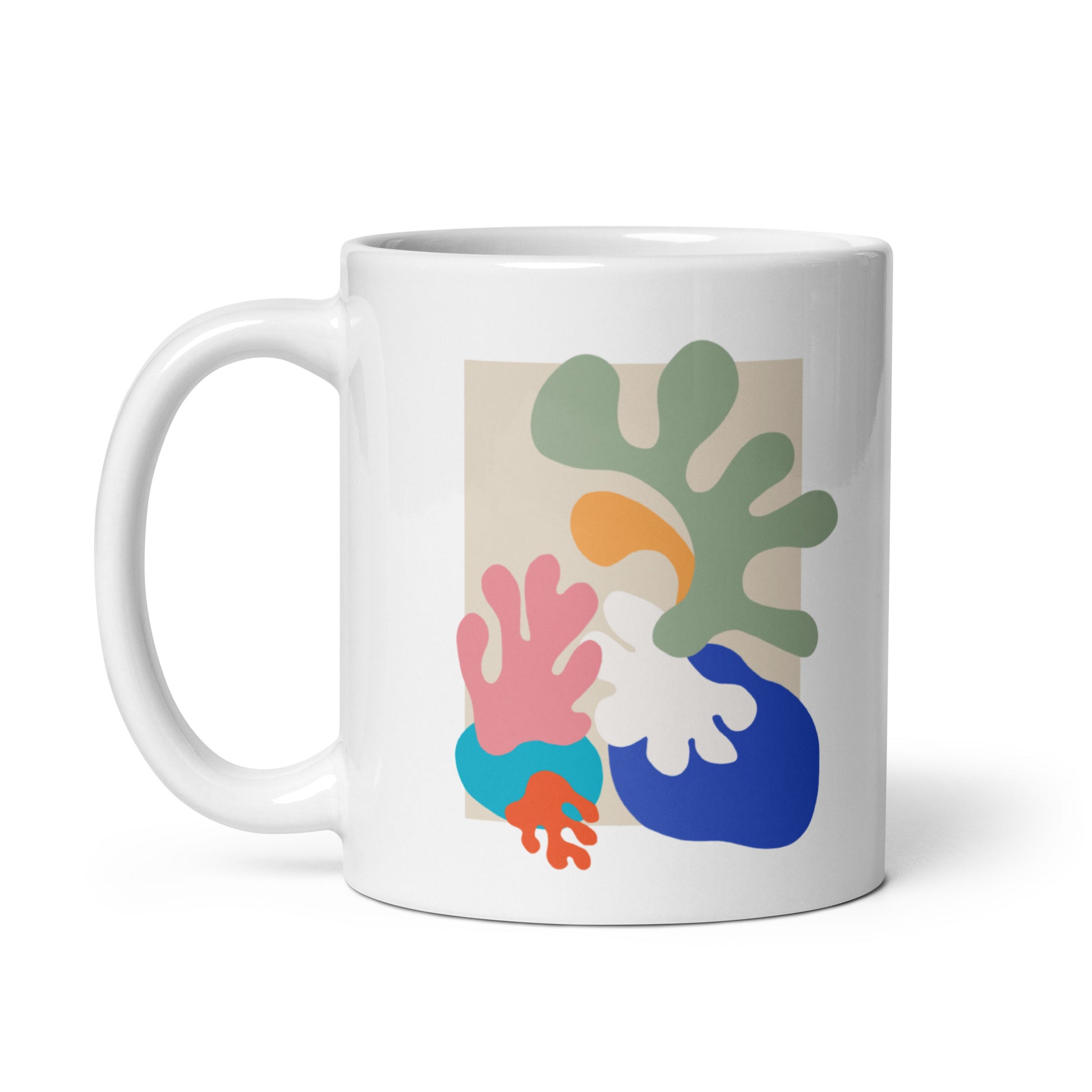 White ceramic mug with colorful abstract botanical shapes, modern coffee cup. Side view 1