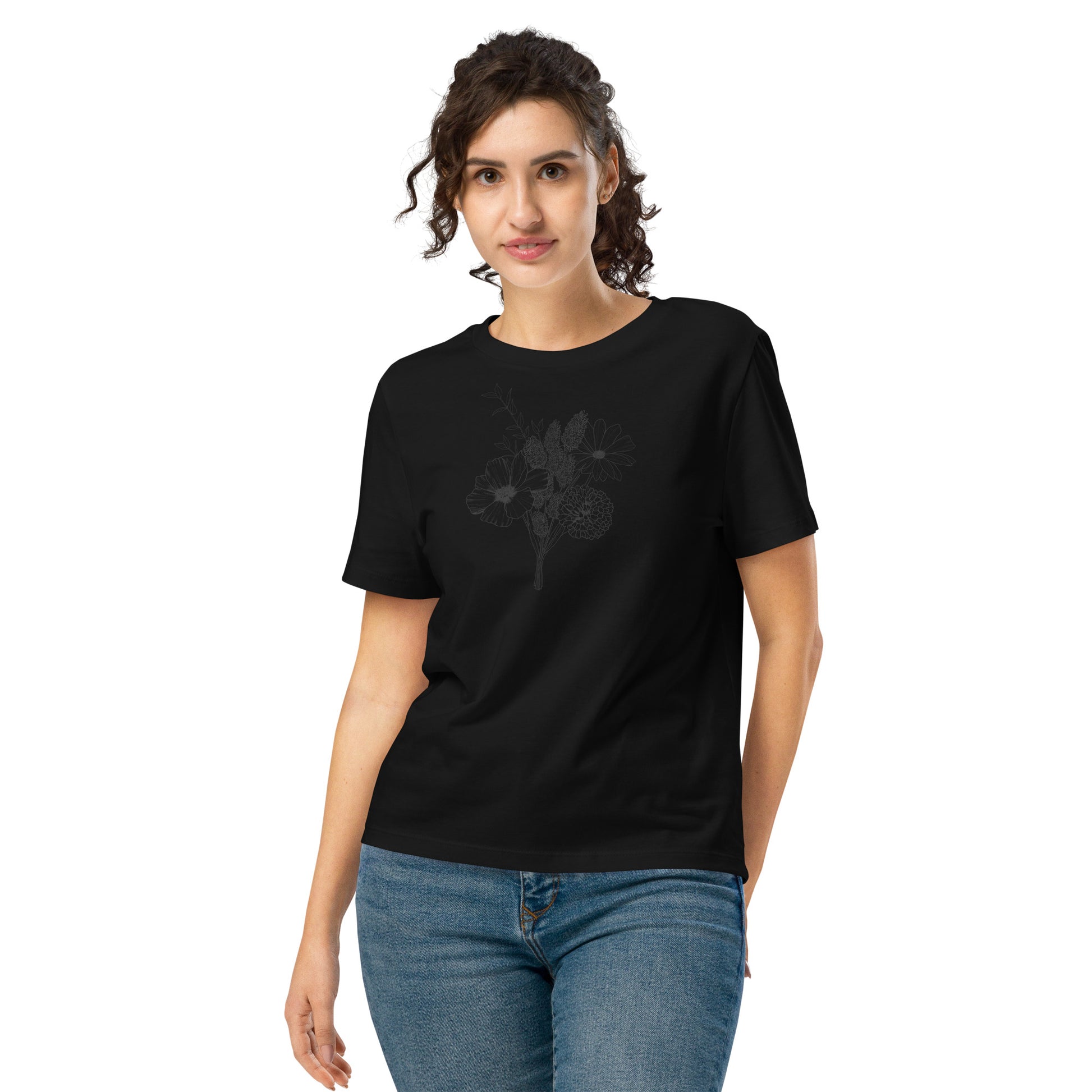 The model wearing a Black organic cotton t-shirt with subtle hand-drawn wildflower sketch – Botanical Sketch design