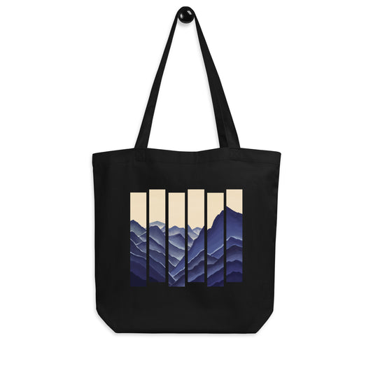 Black Eco tote bag with abstract mountain stripe design in blue tones.