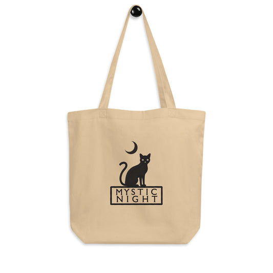 Minimalist oyster color tote bag featuring a black cat sitting under a crescent moon with the text “Mystic Night”.