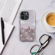 Quiet Moment iPhone 15 Pro Max tough case with a serene meadow design, soft lavender hues, and a matte finish for impact-resistant protection.  On the table view.